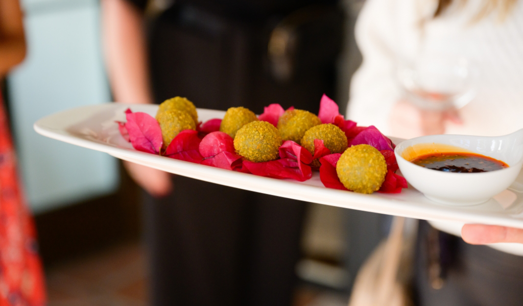 A private chef is holding a tray of food.